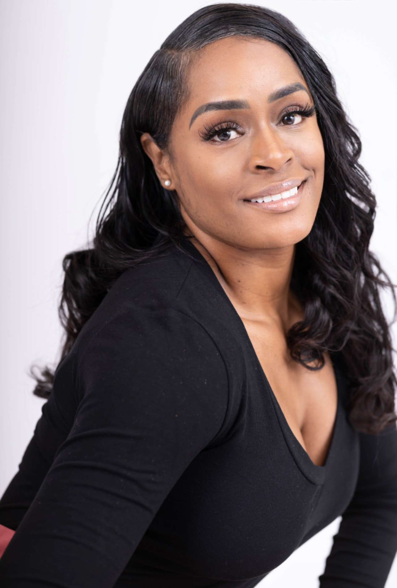 Aubree Bravo — black v-neck, over-the-shoulder look