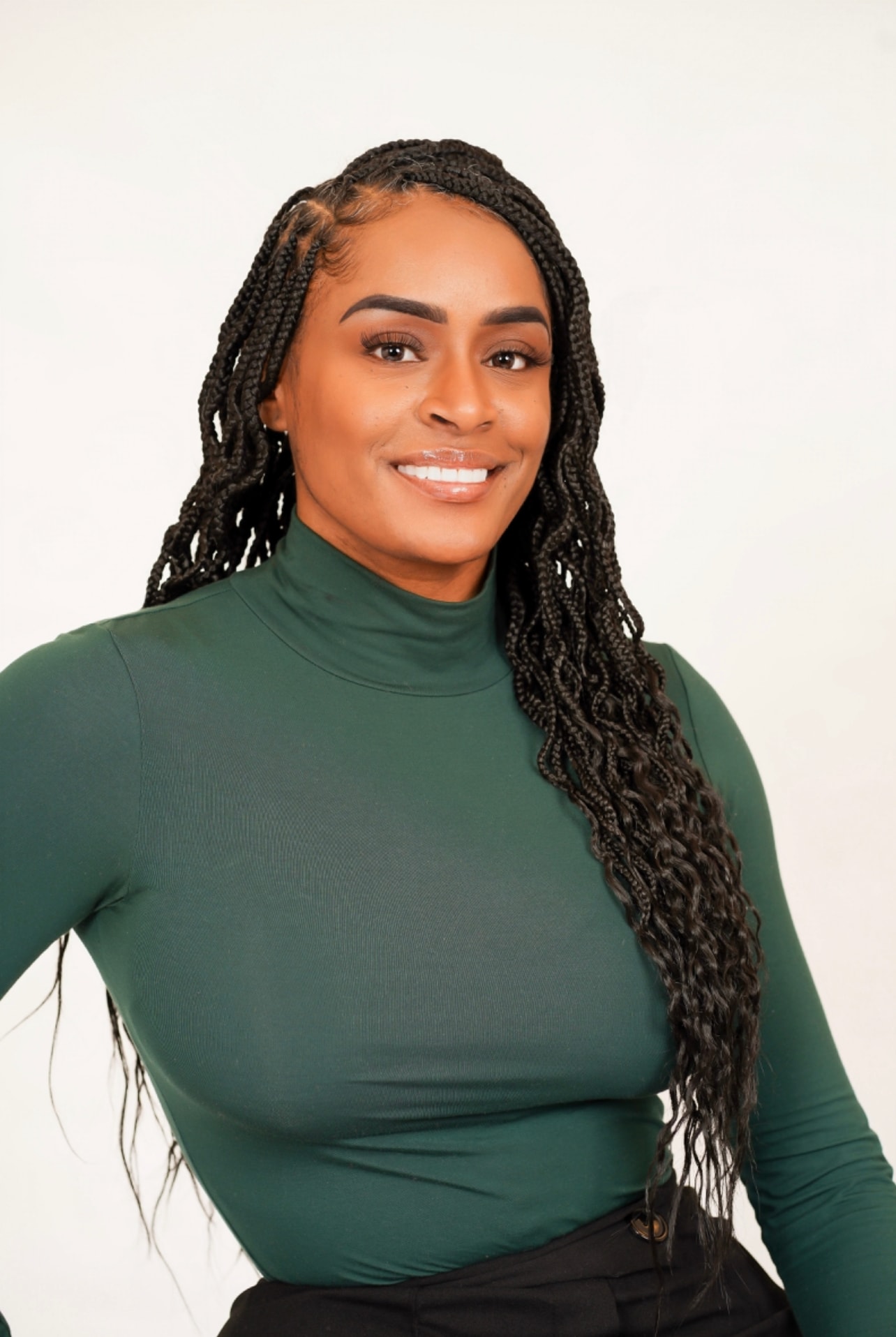 Aubree Bravo — green turtleneck, long braids