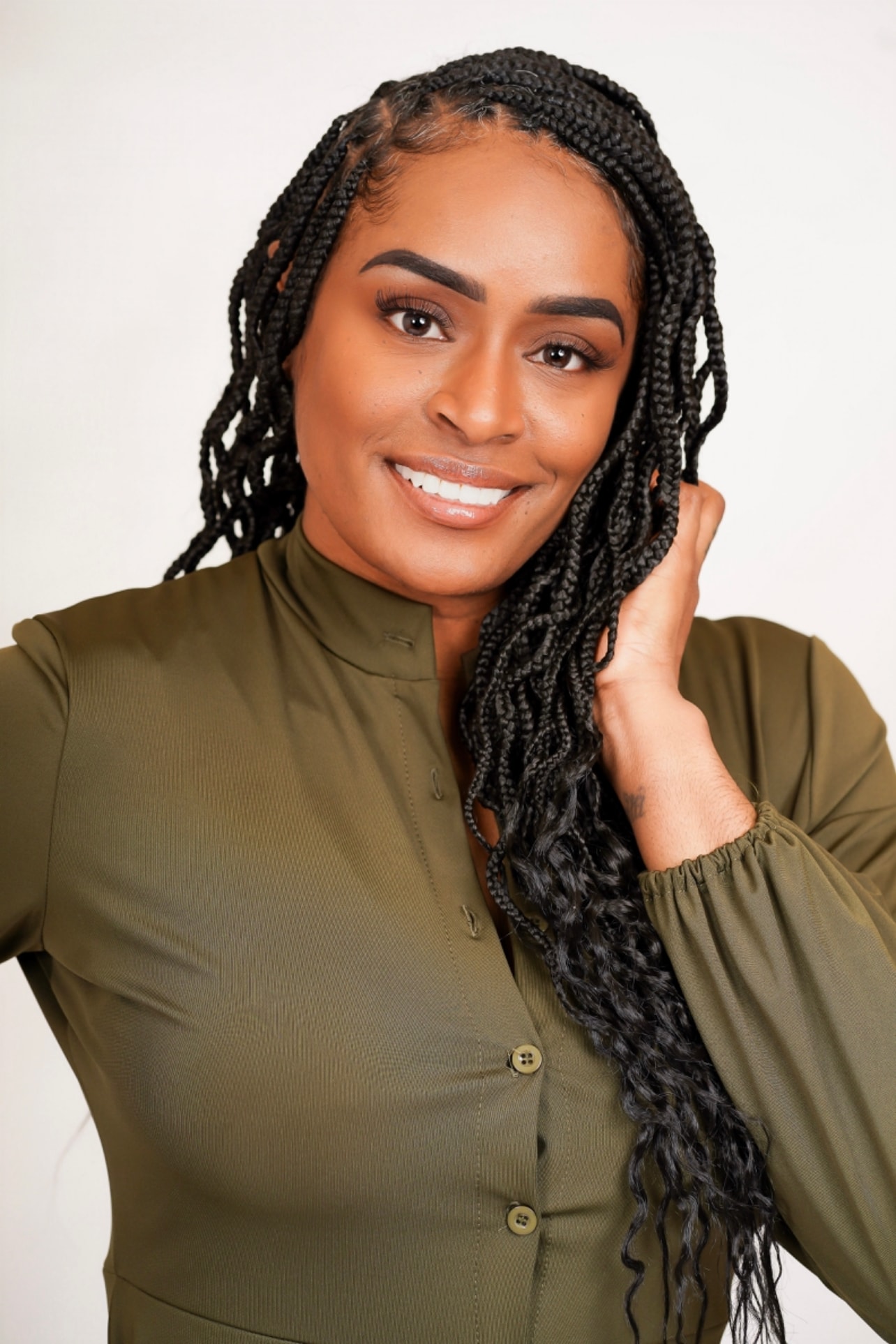 Aubree Bravo — olive blazer, long braids