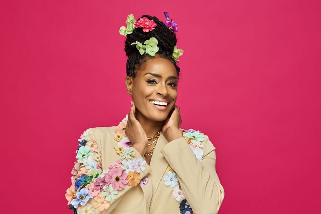 Aubree Bravo — floral blazer, big smile