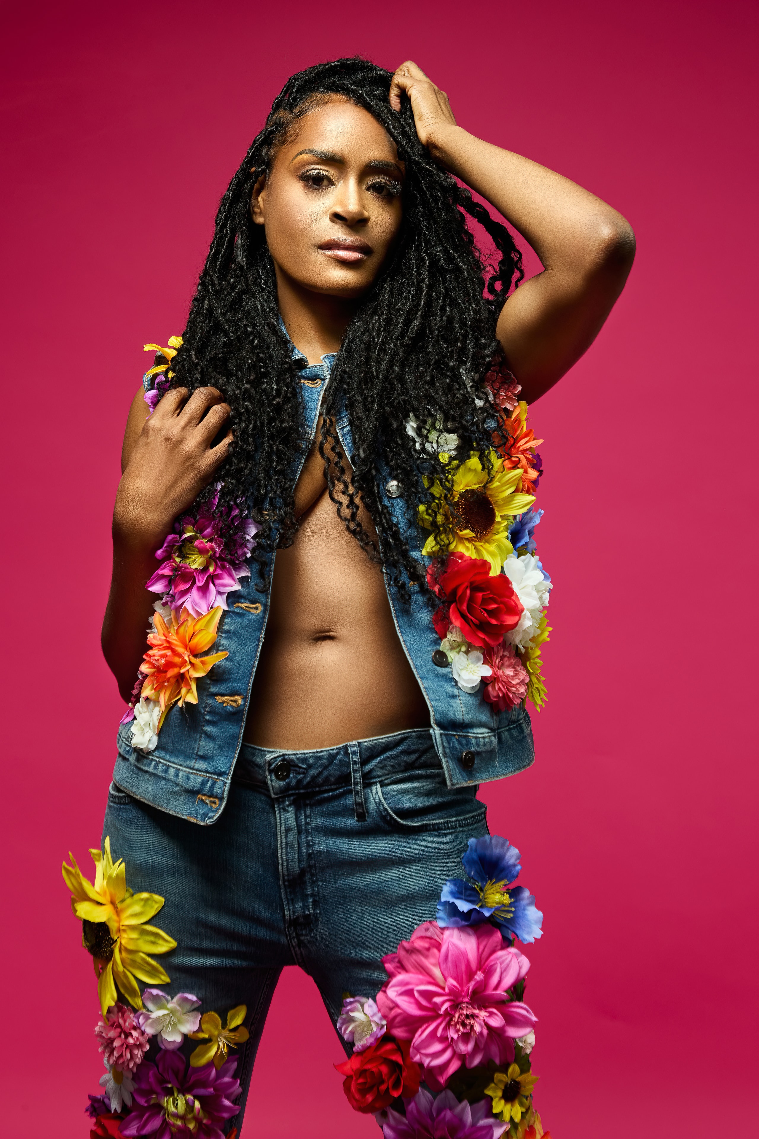 Aubree Bravo — floral denim vest, hands in hair